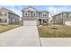 Charming two-story home with blue siding, brick accents, a two-car garage, and a well-manicured front lawn at 6713 Cardiff Dr, McCordsville, IN 46055