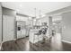 Modern kitchen featuring an island with seating, stainless steel appliances, and white cabinets at 6713 Cardiff Dr, McCordsville, IN 46055
