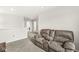 Second floor loft area with a gray reclining couch and plush carpet that is ideal for a relaxed home life at 6713 Cardiff Dr, McCordsville, IN 46055
