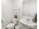 Modern powder room featuring a pedestal sink and toilet at 6713 Cardiff Dr, McCordsville, IN 46055