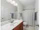 Bright bathroom with single vanity, vinyl floors, and shower with curtain at 681 Greenford N Trl, Carmel, IN 46032