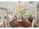 Dining room with hardwood floors, an elegant chandelier, and an archway to an open living area at 681 Greenford N Trl, Carmel, IN 46032