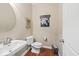 Modern half-bathroom featuring a sleek sink, toilet, and contemporary decor elements for a stylish and functional space at 681 Greenford N Trl, Carmel, IN 46032