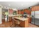 Bright kitchen featuring a center island with seating, granite countertops, and modern stainless steel appliances at 681 Greenford N Trl, Carmel, IN 46032