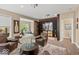Spacious living room with a wine cellar, wooden floors, comfortable leather seating, and exercise room access at 681 Greenford N Trl, Carmel, IN 46032
