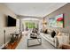 Bright living room featuring an open layout, neutral decor, and large windows overlooking a serene outdoor view at 681 Greenford N Trl, Carmel, IN 46032