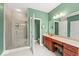 Bright bathroom with double vanity, glass shower, and green painted walls at 681 Greenford N Trl, Carmel, IN 46032