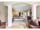 Bright main bedroom featuring carpet floors, decorative columns, large bed, and seating area at 681 Greenford N Trl, Carmel, IN 46032