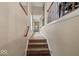 Carpeted staircase featuring decorative wrought iron railing and natural light from the landing window at 681 Greenford N Trl, Carmel, IN 46032