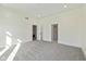 Spacious empty bedroom with soft carpet, white walls and two entrances at 711 N Fenton Ave, Indianapolis, IN 46219