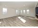 Expansive bonus room featuring hardwood floors and abundant natural light from multiple windows at 711 N Fenton Ave, Indianapolis, IN 46219