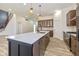 Modern kitchen featuring a large island, stainless steel appliances, and stylish pendant lighting at 711 N Fenton Ave, Indianapolis, IN 46219