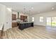 Modern kitchen featuring a large island, stainless steel appliances, stylish backsplash, and ample counter space at 711 N Fenton Ave, Indianapolis, IN 46219