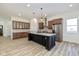 Well-designed kitchen featuring a central island, stainless steel appliances, and wooden cabinets at 711 N Fenton Ave, Indianapolis, IN 46219