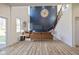 Stylishly furnished living room with comfortable seating, a modern chandelier, and staircase at 711 N Fenton Ave, Indianapolis, IN 46219