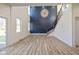 Spacious living room featuring a dramatic two-story wall, modern light fixture, and staircase at 711 N Fenton Ave, Indianapolis, IN 46219