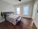 Bright bedroom featuring hardwood floors, neutral paint, ceiling fan and an upholstered bed at 726 E Mccarty St, Indianapolis, IN 46203