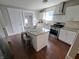 Modern kitchen featuring white cabinets, granite countertops, an island, and stainless steel appliances at 726 E Mccarty St, Indianapolis, IN 46203