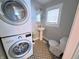 Convenient laundry room with stacked washer and dryer and patterned tile flooring at 726 E Mccarty St, Indianapolis, IN 46203