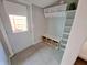 Mudroom with grey flooring, white door and plenty of space to hang coats and store items at 726 E Mccarty St, Indianapolis, IN 46203