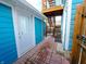 Inviting side entrance with brick pavers, a white door, and wooden stairs at 726 E Mccarty St, Indianapolis, IN 46203