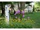 Charming backyard featuring colorful flower gardens and a quaint birdhouse, perfect for nature lovers at 7971 Clearwater Ct, Indianapolis, IN 46256