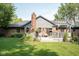 Spacious backyard with a deck, brick chimney, and mature trees, perfect for entertaining at 7971 Clearwater Ct, Indianapolis, IN 46256