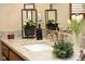 Bathroom features granite counters, gold fixtures, floral accents, and natural light at 7971 Clearwater Ct, Indianapolis, IN 46256