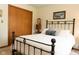 Bedroom with iron bed, wood trim, and neutral colors at 7971 Clearwater Ct, Indianapolis, IN 46256