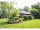 Mature landscaping surrounds this brick home, enhancing its curb appeal at 7971 Clearwater Ct, Indianapolis, IN 46256
