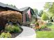 A winding walkway leads to the front entrance, framed by landscaped gardens and an American flag at 7971 Clearwater Ct, Indianapolis, IN 46256
