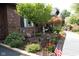 Landscaped front yard featuring brick accents, mature trees, American flags, and walkway at 7971 Clearwater Ct, Indianapolis, IN 46256