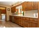 Functional kitchen featuring wood cabinets, laminate countertops, and stainless steel appliances at 7971 Clearwater Ct, Indianapolis, IN 46256