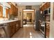 Well-lit kitchen featuring stainless steel appliances and wooden cabinets at 7971 Clearwater Ct, Indianapolis, IN 46256