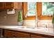 A Kitchen with stainless steel sink, faucet and white countertops with wood cabinets at 7971 Clearwater Ct, Indianapolis, IN 46256