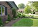 Landscaped garden bed with lush hydrangeas and evergreen shrubs accents a brick home at 7971 Clearwater Ct, Indianapolis, IN 46256