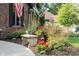 Lush landscaping with stone bench accents the front yard's curb appeal at 7971 Clearwater Ct, Indianapolis, IN 46256