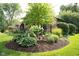 A well-maintained garden bed with mature shrubbery and lush plants adds curb appeal at 7971 Clearwater Ct, Indianapolis, IN 46256