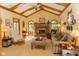 Bright living room with vaulted ceilings, exposed beams, brick fireplace, and comfortable seating at 7971 Clearwater Ct, Indianapolis, IN 46256