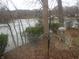 Picturesque lake view with mature trees and a bird feeder in a serene setting at 8 Lake Hart, Mooresville, IN 46158