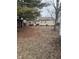 View of back of home with mature trees surrounding a spacious backyard at 8833 Crawfordsville Rd, Indianapolis, IN 46234
