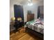 Bedroom showcases desk, comic bedding, wood floors, and ample natural light at 8833 Crawfordsville Rd, Indianapolis, IN 46234