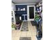 This laundry room includes shelving, washer, dryer, and contrasting blue wall at 8833 Crawfordsville Rd, Indianapolis, IN 46234