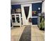 This mudroom features tile flooring, blue accent wall, white door with storage at 8833 Crawfordsville Rd, Indianapolis, IN 46234
