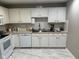 Well-equipped kitchen with white cabinetry, modern appliances, and ample counter space at 8960 Stepping Stone Way, Avon, IN 46123