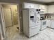 Well-lit kitchen with white cabinetry, modern appliances, and easy access to laundry at 8960 Stepping Stone Way, Avon, IN 46123