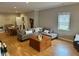 Inviting living room featuring wood floors, neutral paint, dining area, and abundant natural light at 8960 Stepping Stone Way, Avon, IN 46123