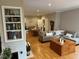Open-concept living room with built-in shelves, wood floors, and a view of the dining area at 8960 Stepping Stone Way, Avon, IN 46123