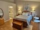 Cozy main bedroom with an en-suite bathroom, wood floors, and soft lighting at 8960 Stepping Stone Way, Avon, IN 46123