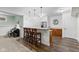 Basement wet bar featuring a bar countertop, stylish pendant lighting, wood cabinets, and a stainless steel refrigerator at 10802 Giselle Way, Fishers, IN 46040